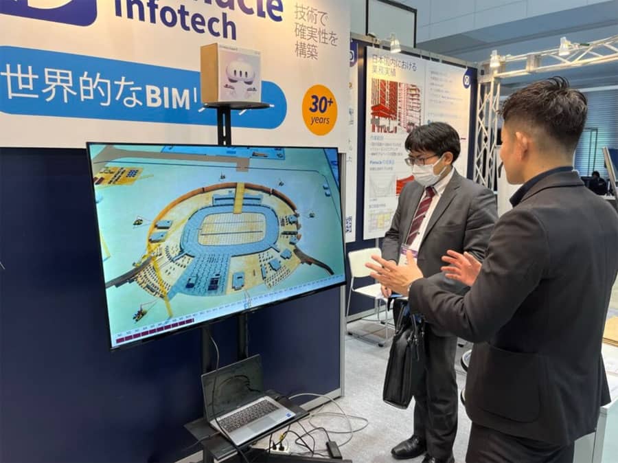General contractors at Pinnacle's booth in Japan Build 2023 discussing future possibilities in building information modeling