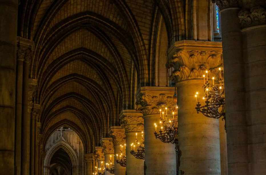 Church interior pillars lit up with chandeliers