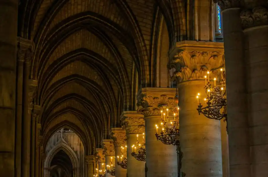 Church interior pillars lit up with chandeliers