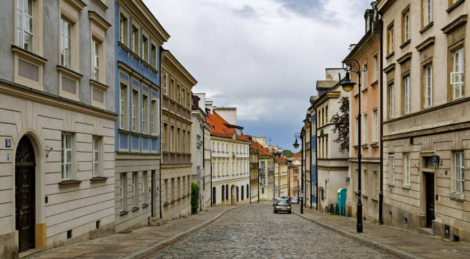 Cobblestoned street lined with buildings